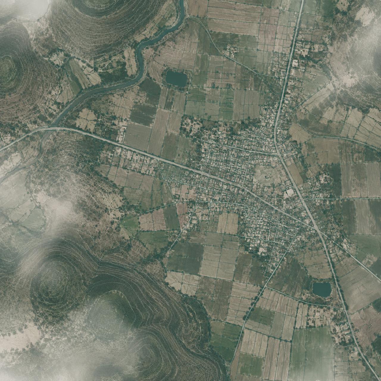 Aerial view of farmland and a town with mapped parcel and road outlines